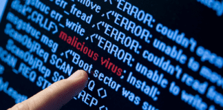 Finger pointing to a red "malicious virus" text embedded within lines of code.